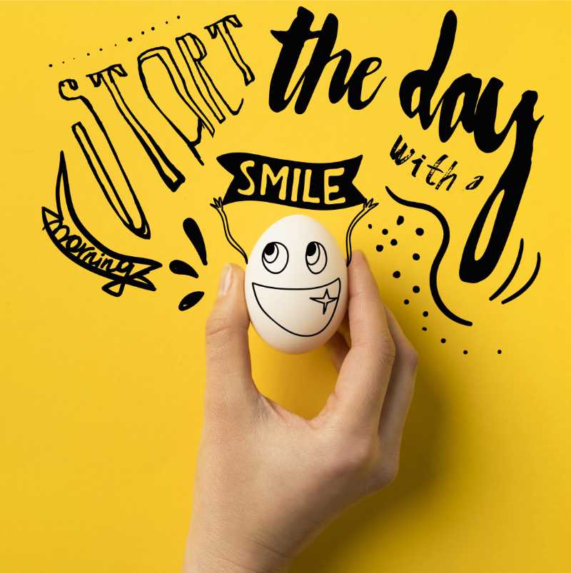 start the day with a smile graphic with funky text and featuring an egg with a happy face